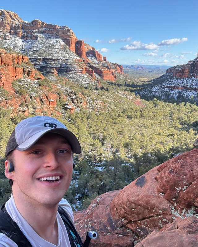 Thomas Karl above a snow-dusted red rock canyon in Sedona